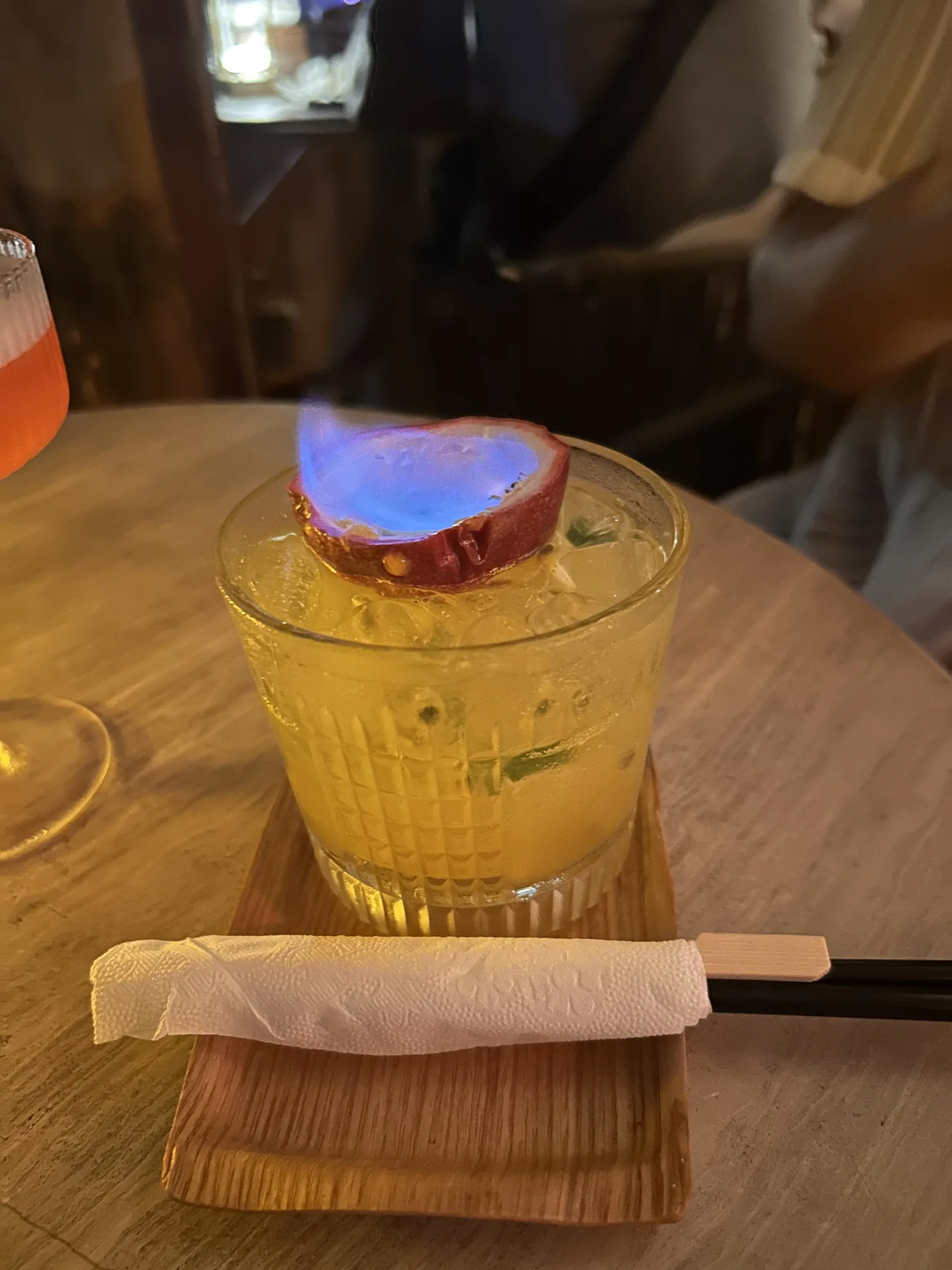 Friend’s flaming passionfruit drink at The Roof